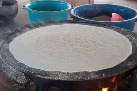Cooking manioca in indian village, Venezuela