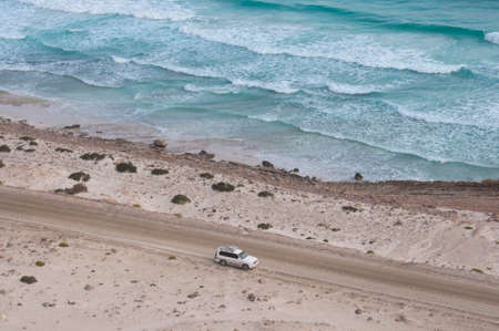Car at the coast of ocean. Socotra island, Yemenの写真素材