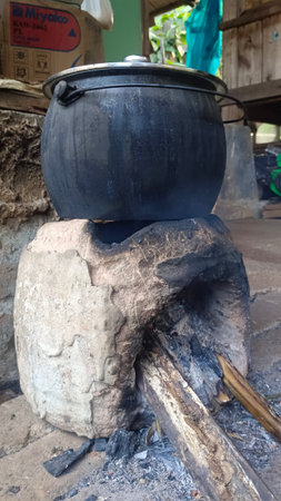 Cooking pot on a cauldron on the fire in the villageの写真素材