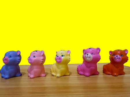 Small plastic colorful cat figures built on tableの写真素材