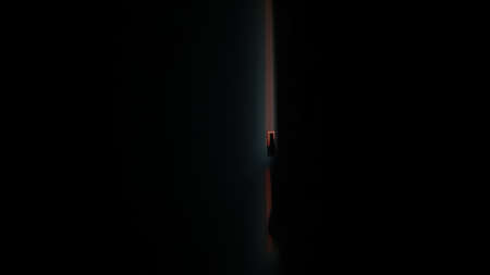 A dark room with sunlight shining through the curtains.