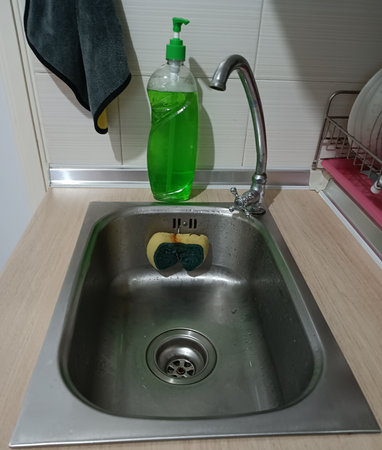 Sink with sponge and dishwashing liquid.の写真素材
