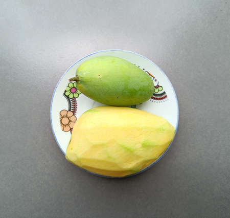 green mango on a white plate thai fruit summer, Top viewの写真素材