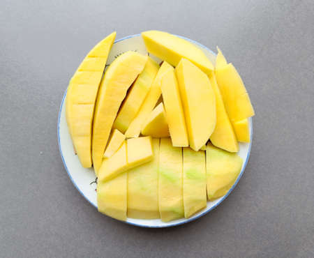 green mango sliced on a white plate thai fruit summer, Top viewの写真素材