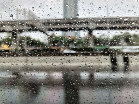 Rain drops on window glass surface. Rainy backgroundの写真素材
