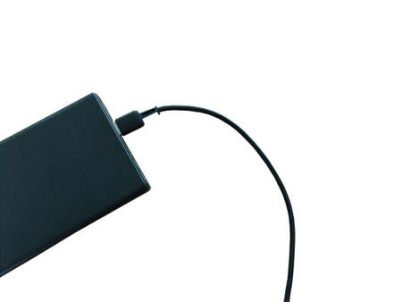 black power bank with USB cable isolated on white background.の写真素材