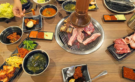 Full set of beef and pork ready for grill on stove serve with vegetable, Tteokbokki , fried chicken and side dish, Korean style barbecue, selective focusの写真素材