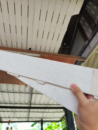 Hand hold old ceiling is damaged and needs to be repaired.の写真素材
