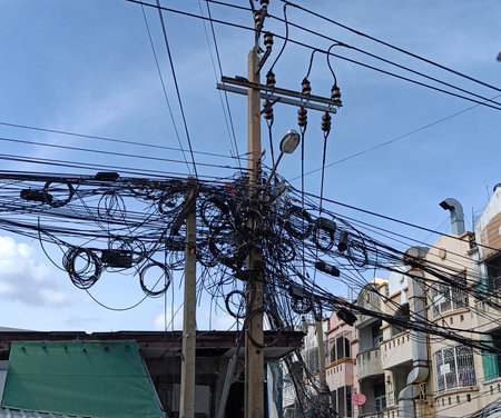 Messy electricity wires on the pole, The chaos of cables and wires on an electric pole in Thailandの写真素材