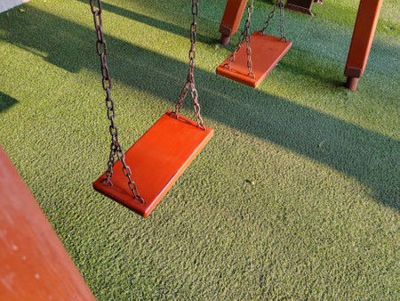 Swing playground in the morning sunlight in spring