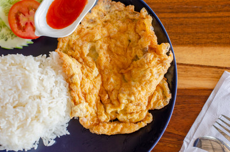 Omelet rice on wooden table, Thai Breakfast,  top viewの写真素材