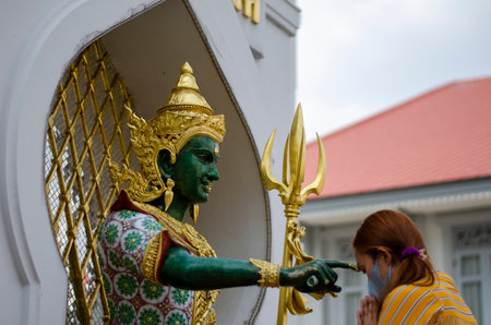 Bangkok, Thailand - April 22, 2023: Worship Devaraj Neramit or Thep Tanjai statue, Thewarat Kunchorn Worawihan Templeのeditorial素材