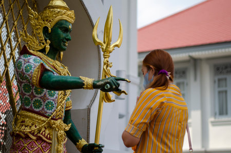 Bangkok, Thailand - April 22, 2023: make a wish Devaraj Neramit or Thep Tanjai statue, Thewarat Kunchorn Worawihan Templeのeditorial素材