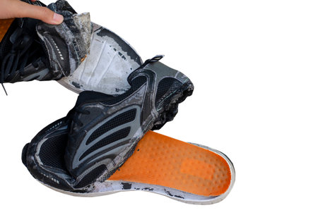 Unrepairable, broken old black shoes isolated on white background with clipping pathの写真素材