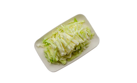 Cut fresh cabbage on dish. isolated on white background with clipping pathの写真素材