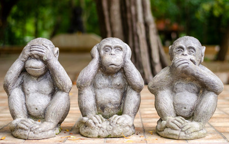 Three monkey small statues with the concept of Close your eyes, close your ears, close your mouth.