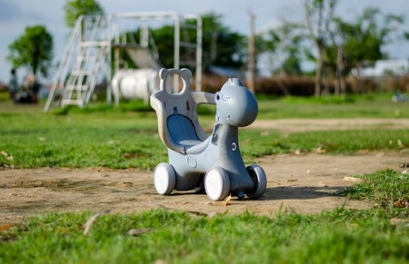 Children's bicycle in the shape of a cartoon dinosaur in the playgroundの写真素材