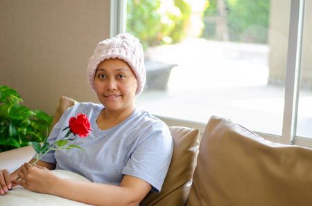 Asian woman with cancer, she smiles happily, receives good support