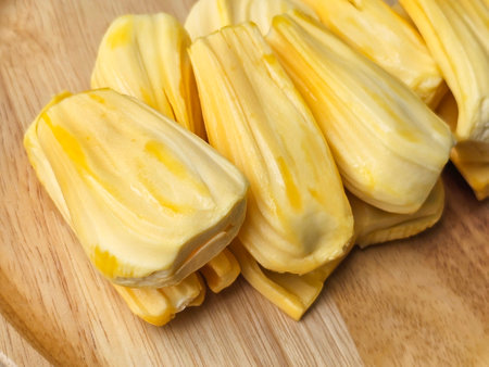 closeup side view of jackfruit pulp on wooden boardの写真素材