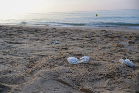 Scraps of paper on the beach and pollute the environment.の写真素材
