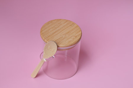 Top view empty glass jar with spoon for food use. on pink backgroundの写真素材