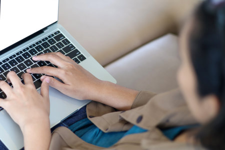 Laptop, Woman hands typing on the keyboard, writing articles, browsing social media, and managing an online business. with copy space. Top viewの写真素材