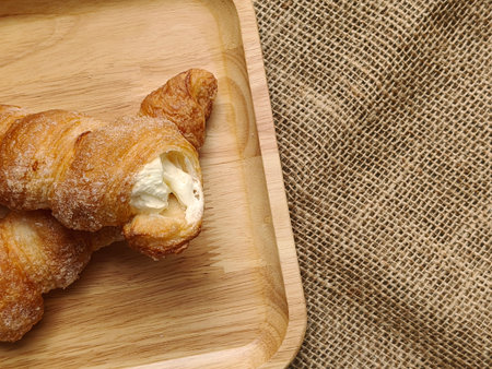 cream horn bread pastries on wooden board. Top view with Copy space