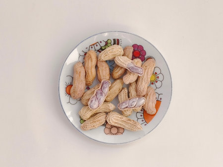 Top view of Boiled peanuts served on a plate on a white background.の写真素材