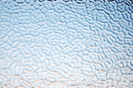an abstract photo of a plane of textured blue tinted glass     