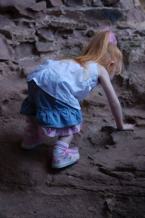 a little girl climbing a castle wallの写真素材