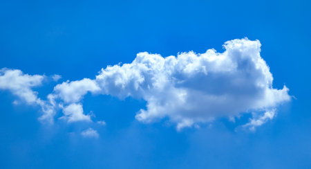 Cotton ball A lonely cloud moves freely across the blue sky. The gentle movement of an atmospheric...