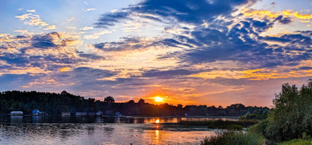 A fabulous, captivating picture. Dusk, Sunset Sky Clouds in the Evening colorful Orange, Yellow, Pink Red sunlight Dramatic storm clouds on Twilight sky, Landscape horizon Summer Backgroundの写真素材