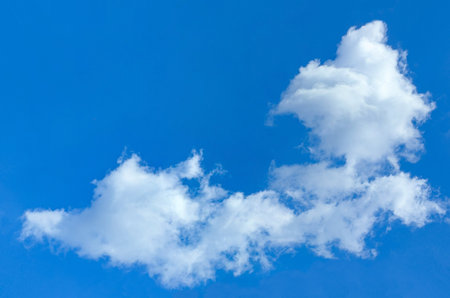 A big fluffy cloud with clear skies. A cloud slowly floats across the sky. Serenity and solitude....