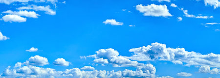 Beautiful clouds on deep blue sky background. Elegant white clouds in daylight after rain. Panorama...