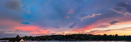 Orange and pink fan clouds scatter. Calm blue evening sky. Wide panoramic view. Fresh air volume...