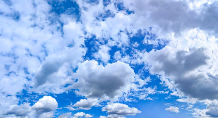 Fan-shaped cirrus clouds scattered by the wind across the daytime sky. A picture drawn by the wind....