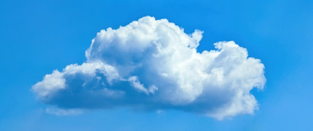 A big fluffy cloud with clear skies. A compound clouds slowly floats across the sky. Serenity and...