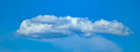Blue sky with few clouds. Abstract shapes of steam cloud. Random white spots are scattered across...