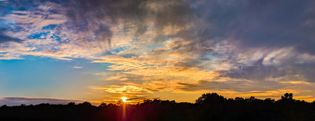 Amazing sunset panorama in a beautiful summer evening. Detailed cascades of multi-level cumulus and...