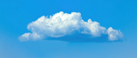 Cotton ball A lonely cloud moves freely across the blue sky. The gentle movement of an atmospheric...