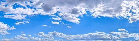 Two sided up and down cloud banner with copy space inscription.. Blue sky filled with many white...