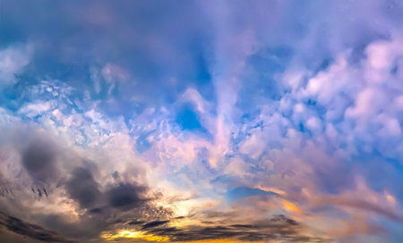 A dramatic sunset in vibrant colors of pink, red, and blue reflected in the river. The edge of the...
