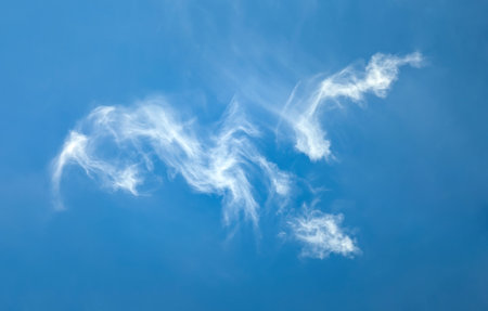 Cirrus horizontal clouds floating across the endless sky. Detailed texture of steam cloud and evaporating moisture. A lone raindrop volumetric soft structure.の写真素材