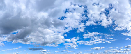 Beautiful blue sky background with cumulus clouds. Large and small vapor structures are arranged in...