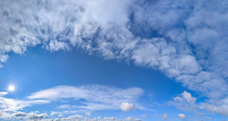 Beautiful blue sky background with cirrus and cumulus clouds. Large and small vapor structures are...