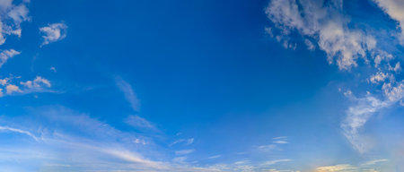 Shadows of sunset clouds. with empty space. Dramatic high-altitude backdrops of gold textured cloud. A panorama of volumetric light and shadow, immersing glowing in deep water contemplation. Majestic scenery light various golden shapes calm.の写真素材