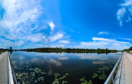 Water and sky banner with copy space inscription. Blue sky filled many white clouds creating a...