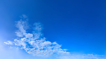 Banner with a pronounced diagonal composition and empty space for your text. A stream of clouds slowly follows the sky. Windy weather of a beautiful day. Cover for a website or mobile application. Sitting giant cotton wool flow.の写真素材