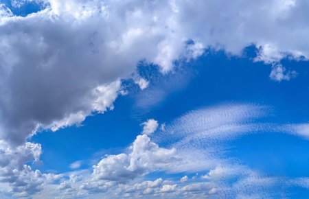 A group of clouds in the form of a wide panorama. Blue background with space for text and a light blue gradient. Violet Sky with Cloud Summer Spring Nature Light on Beautiful Natural sky Backdrop.の写真素材