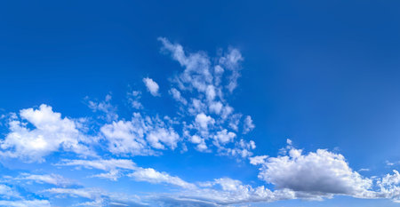 The sky has the light of the sun, the sky is blue, there are small and large clouds alternating and...
